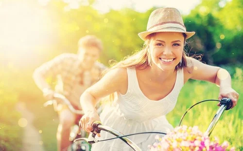 girl guy riding bikes