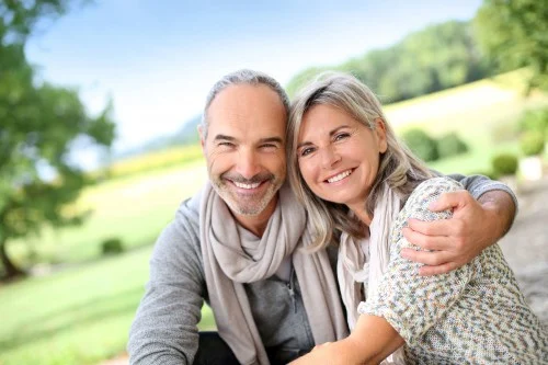 older couple embracing outdoors